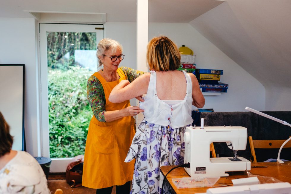 Yvonne from Gathered Threads, pinning and fitting a dress to a Sewing Retreat guest